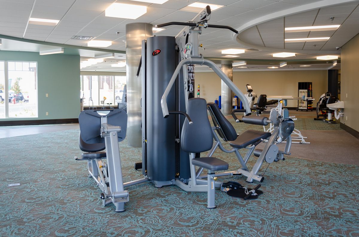 A gym setup featuring a multi-functional weight machine for strength training.