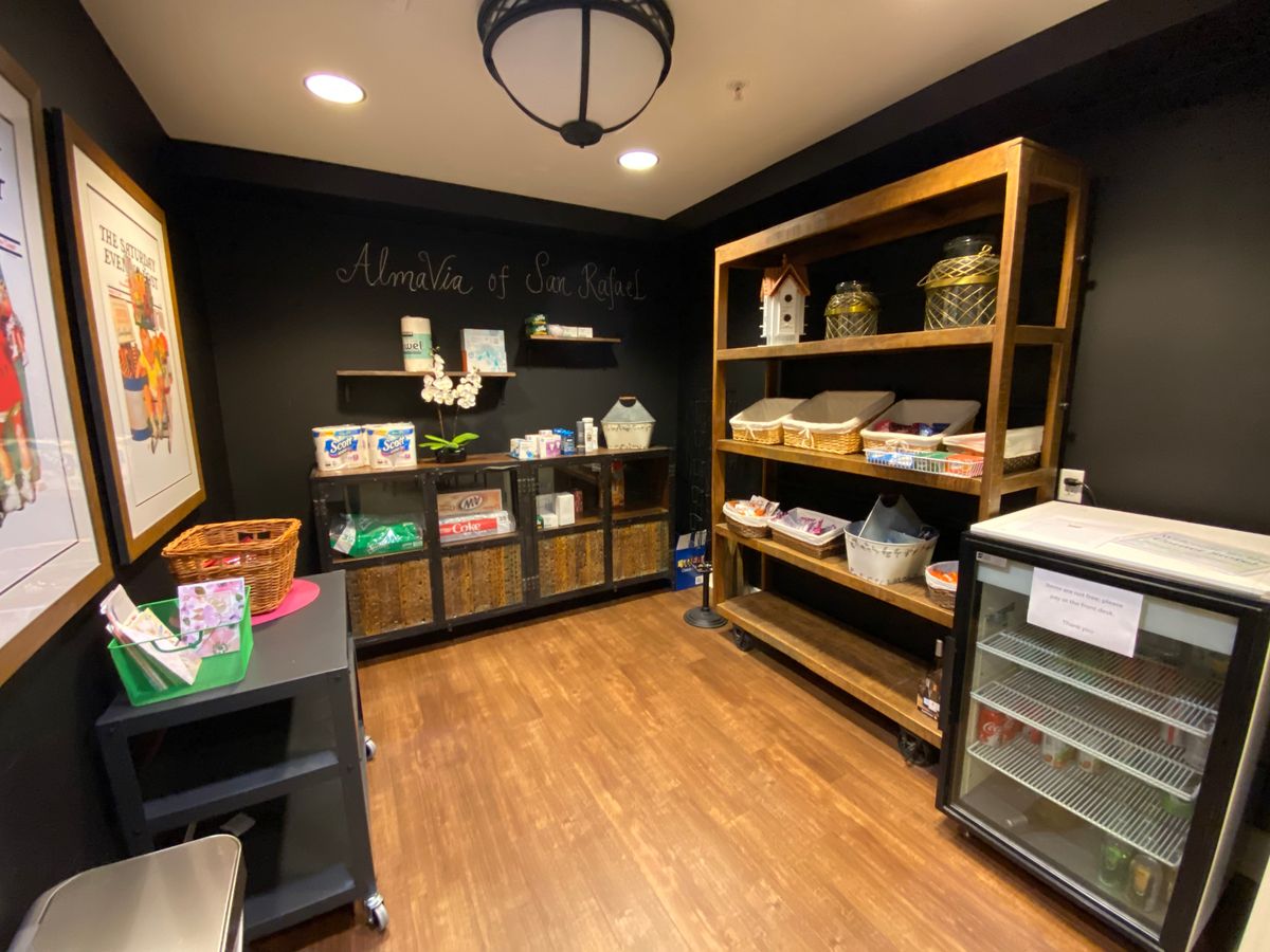 A cozy gift shop with wooden shelves displaying various products.