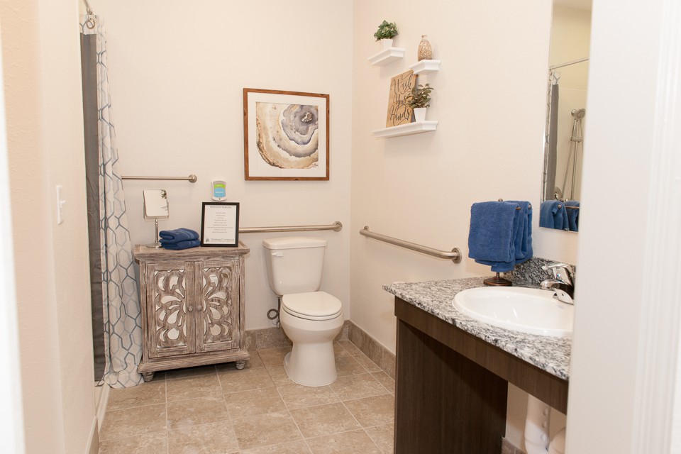 A well-decorated bathroom with a toilet, sink, and stylish decor.