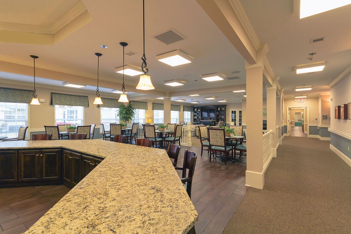 A modern dining area with a bar counter and elegant lighting.
