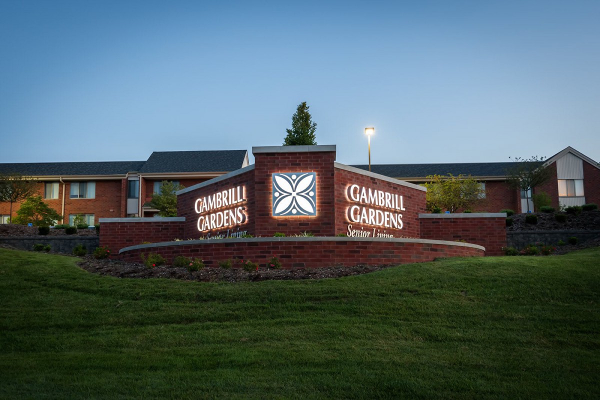Entrance to Campbell Gardens at dusk, featuring illuminated signage.