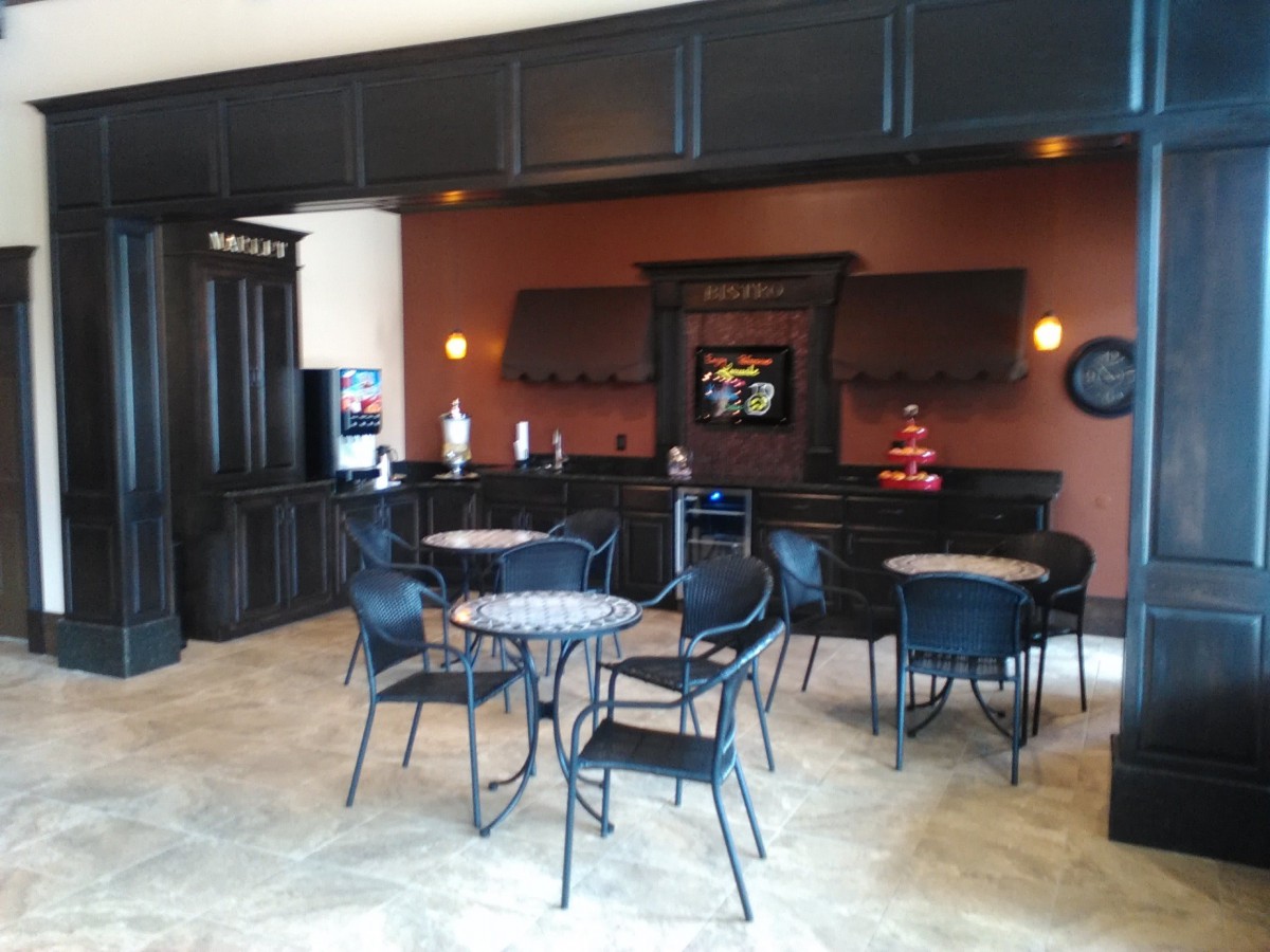 A modern cafe interior with tables and chairs arranged for seating.