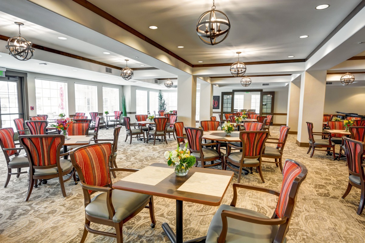A stylish and cozy dining room with elegant furniture and modern lighting.