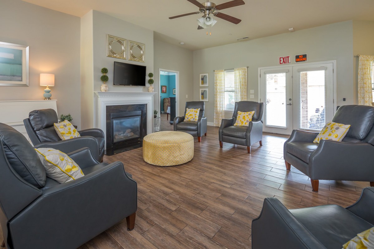 A modern living room with comfortable seating and a cozy fireplace.