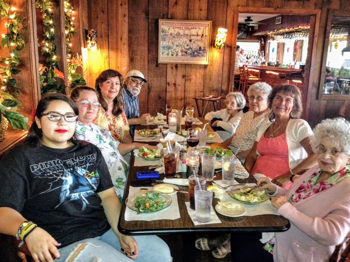 A group of people enjoying a meal together at a restaurant.
