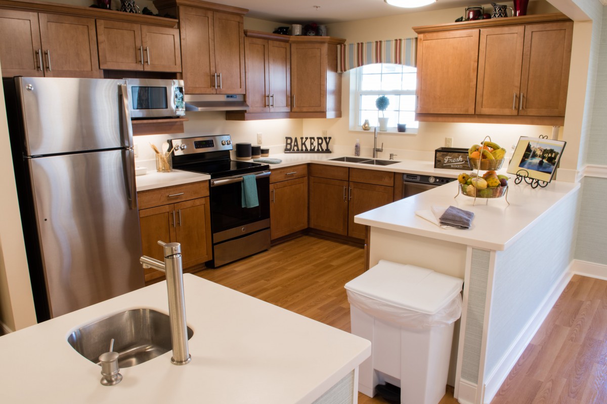 A modern kitchen with wooden cabinets and sleek appliances.