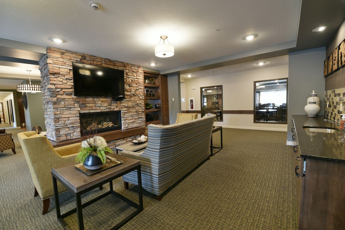 A cozy living room with a fireplace and modern furnishings.