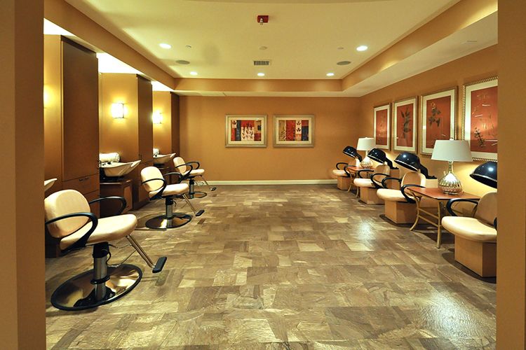 A modern and luxurious salon interior featuring comfortable chairs and stylish decor.