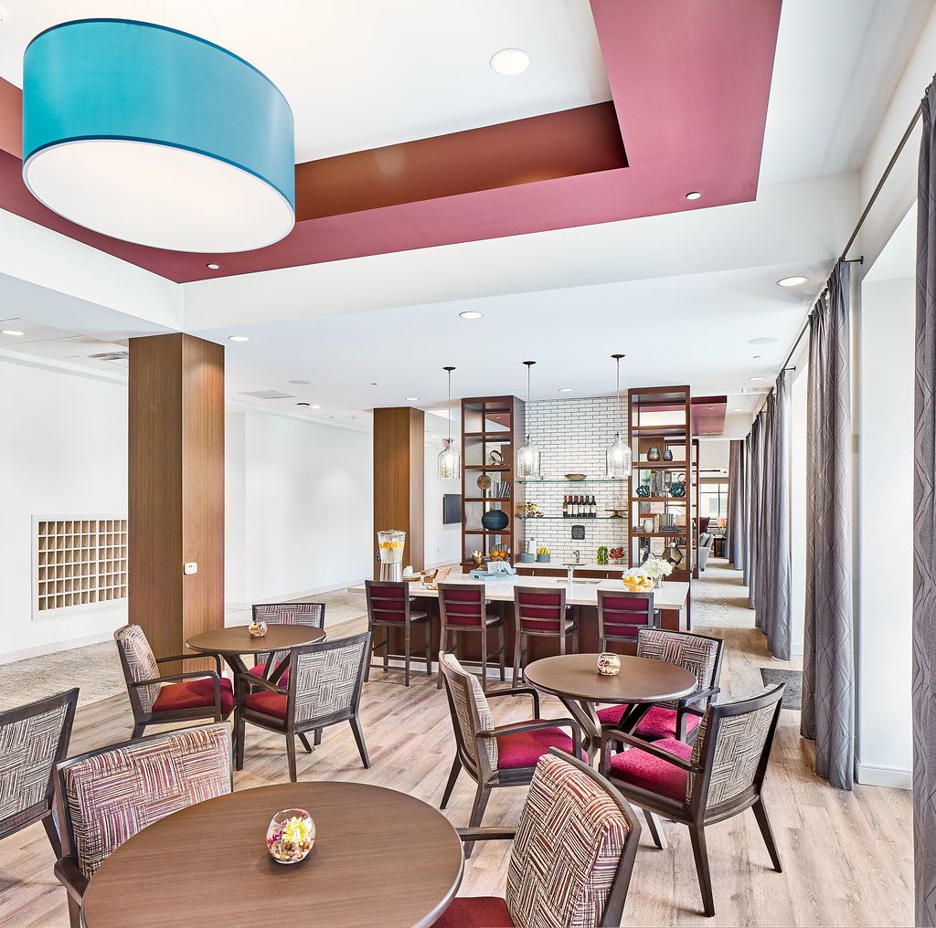A modern dining area with stylish furniture and lighting.
