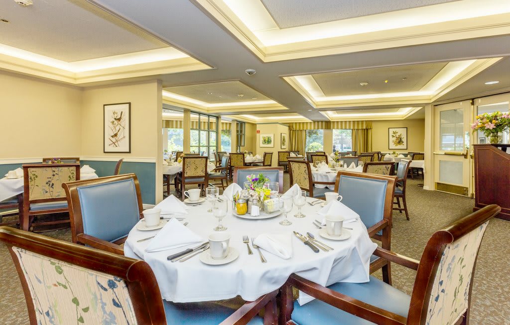 An elegantly set dining room with neatly arranged tables and chairs, creating a luxurious and inviting atmosphere.