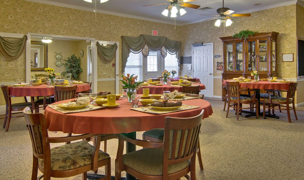 A warmly decorated dining room with tables set for a meal.