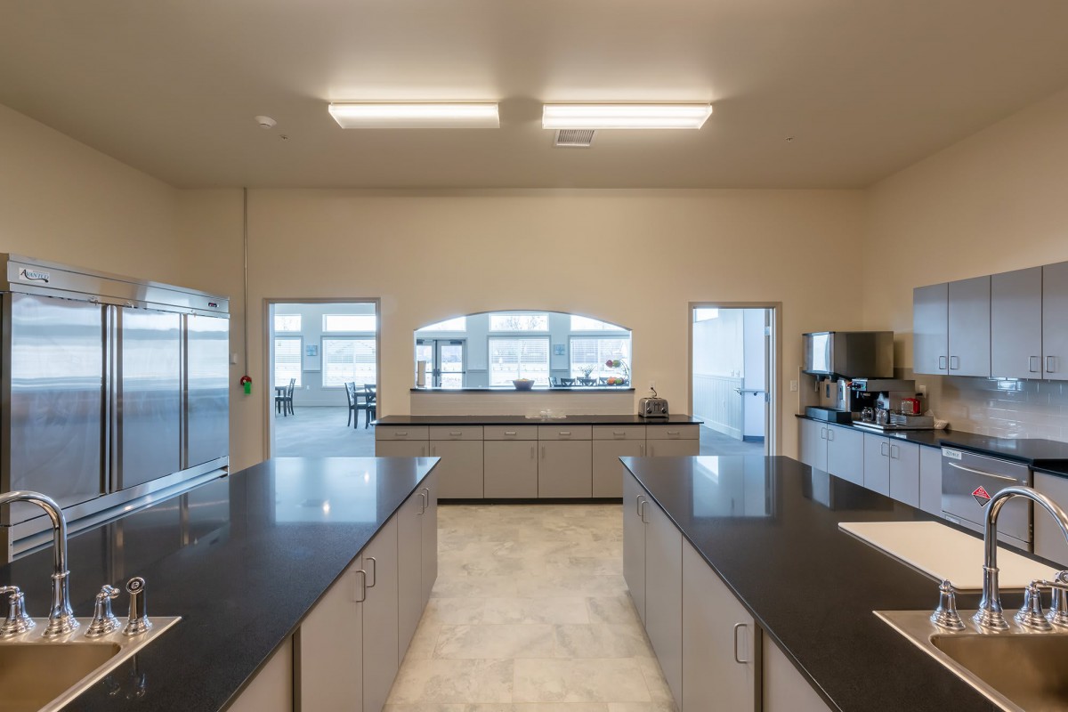 A spacious modern kitchen with large countertops and ample lighting.