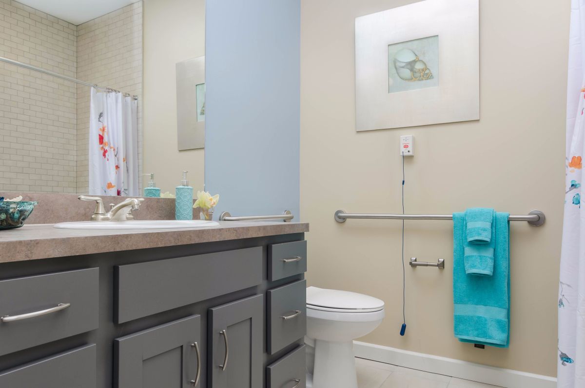 A modern bathroom with a sink, toilet, and decorative elements.