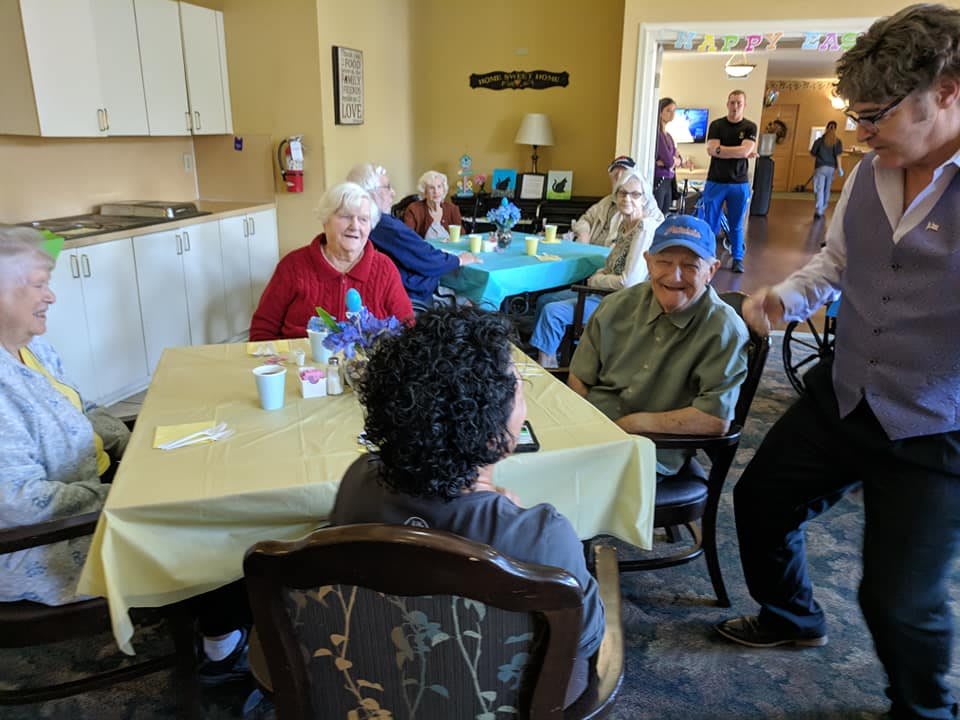 A group of seniors enjoying a social gathering in a community center setting.