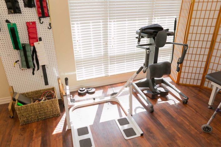 A well-lit home gym with various fitness equipment for personal workouts.