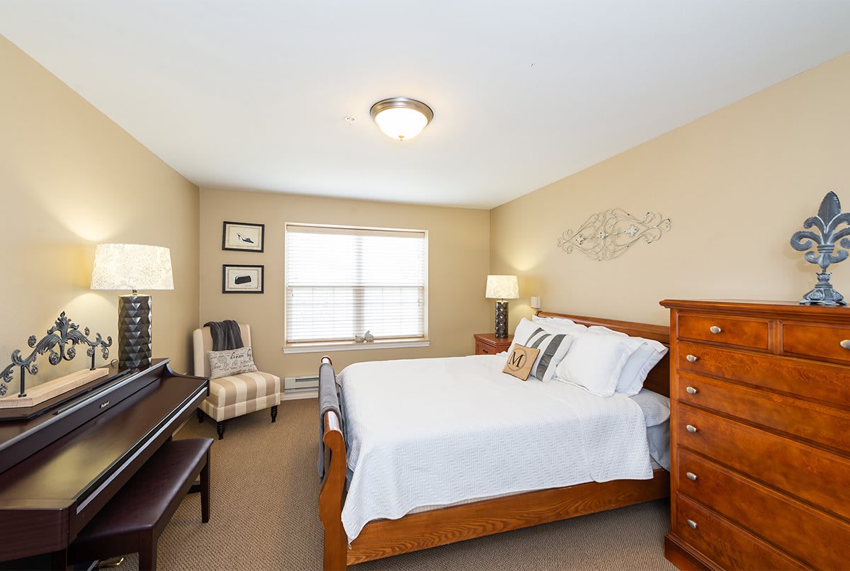 A cozy bedroom with wooden furniture and neutral decor.