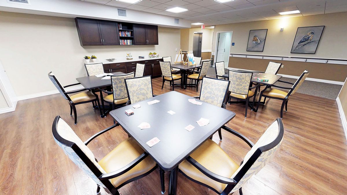 A modern dining area with neatly arranged tables and chairs.