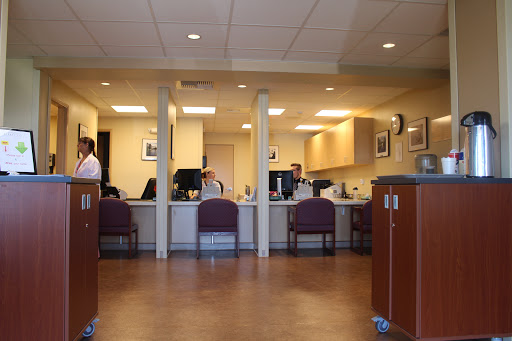 A view of a reception area in a healthcare facility with staff at the front desk.