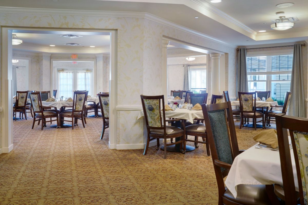 An elegant dining room with neatly set tables and chairs.