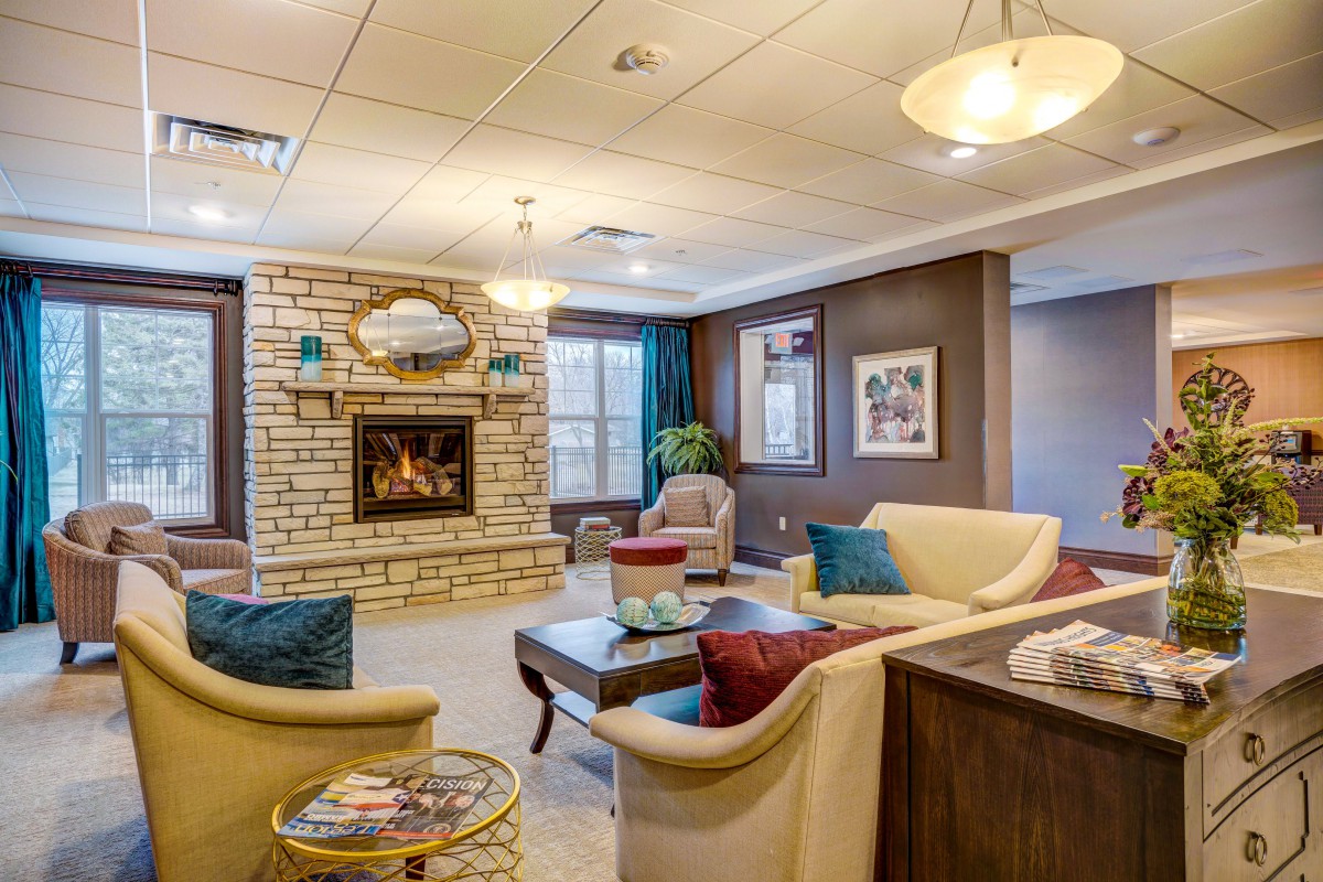 A cozy living room with a central fireplace and comfortable seating arrangement.