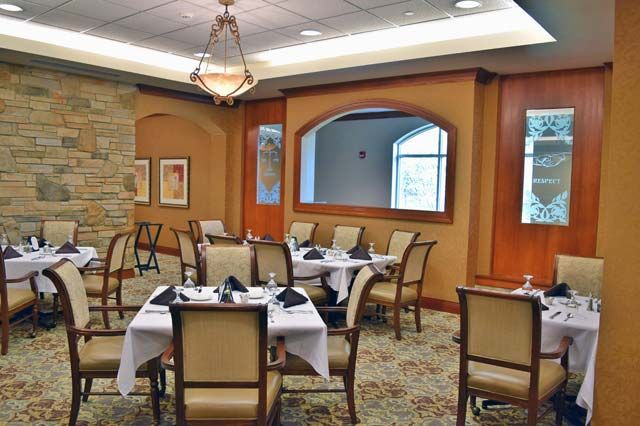 An upscale restaurant dining area with neatly arranged tables and chairs.