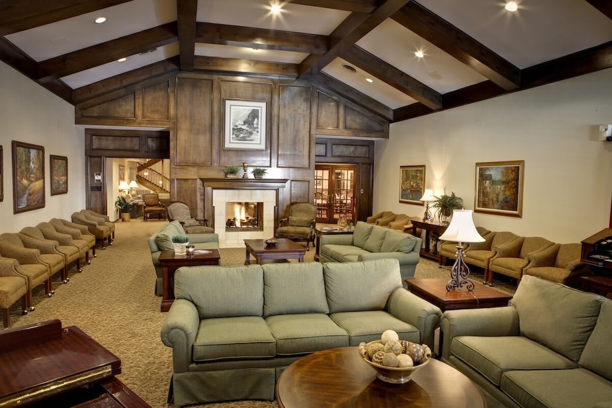 A cozy living room with traditional design, featuring a fireplace and elegant furniture.