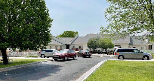 A serene residential neighborhood featuring parked vehicles and well-maintained lawns.