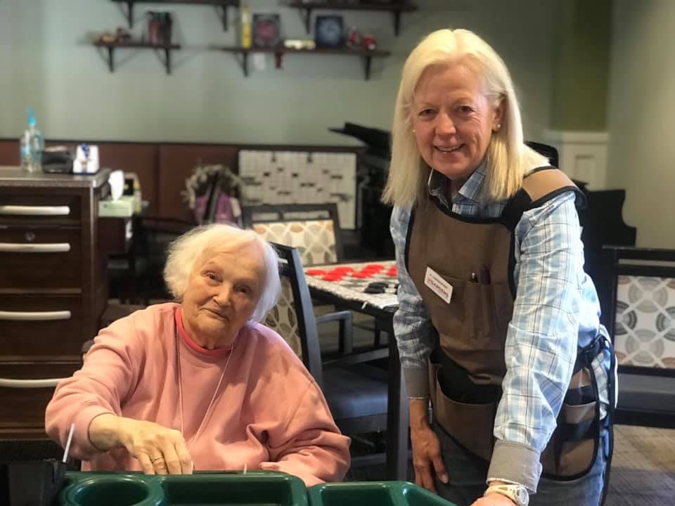 Two women enjoying a moment together in a communal setting.