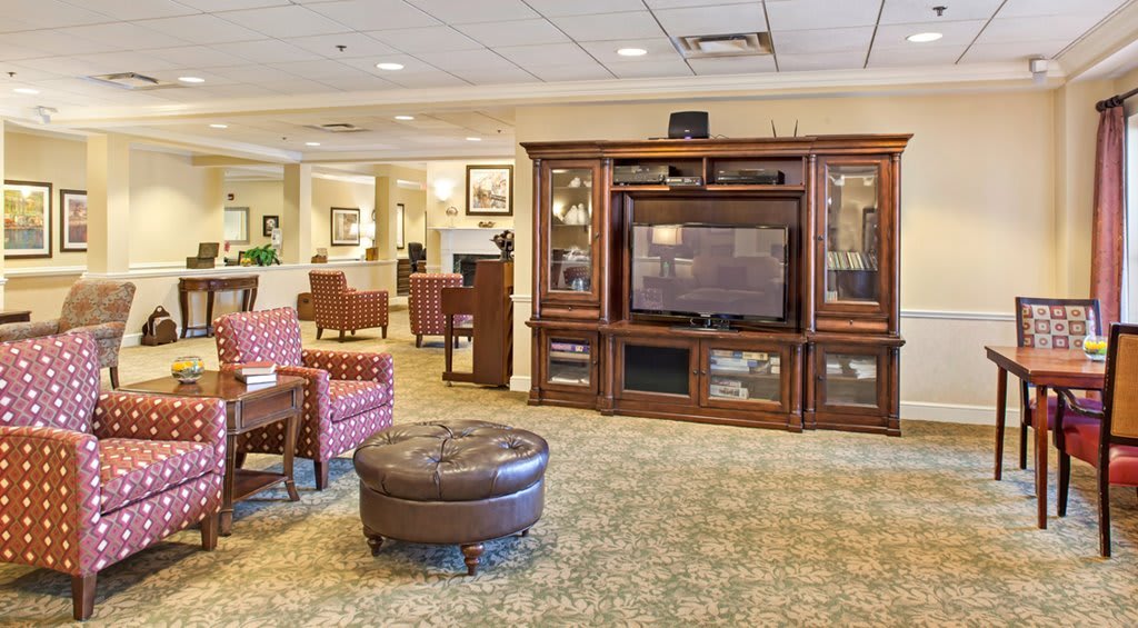 A cozy living room with a large entertainment center and comfortable seating.