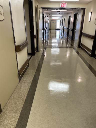 A long hallway with multiple doors on either side.