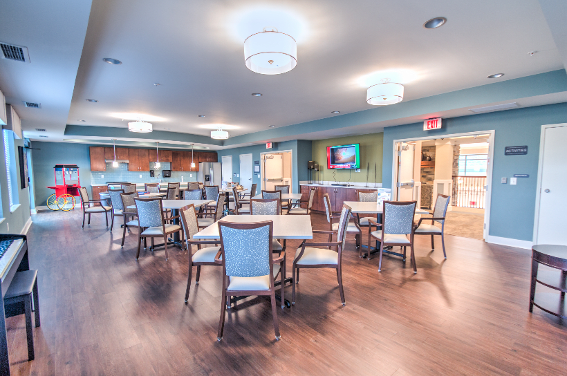 A modern dining area with neatly arranged tables and chairs.