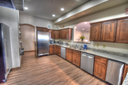 A modern kitchen featuring wooden cabinets and stainless steel appliances.