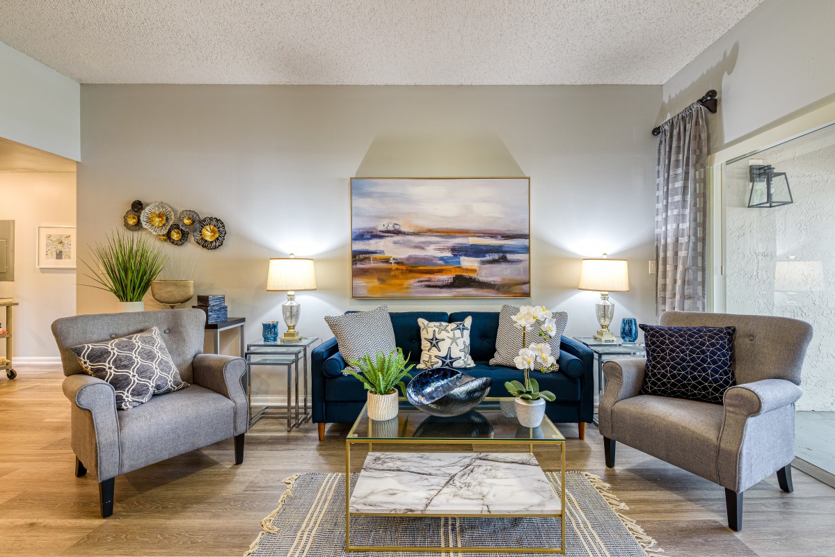 A beautifully decorated living room featuring two sofas, a central coffee table, and artistic wall decor.