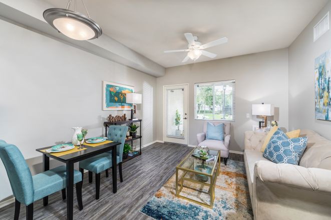 A modern and cozy living room featuring a dining area, stylish furnishings, and tasteful decor.