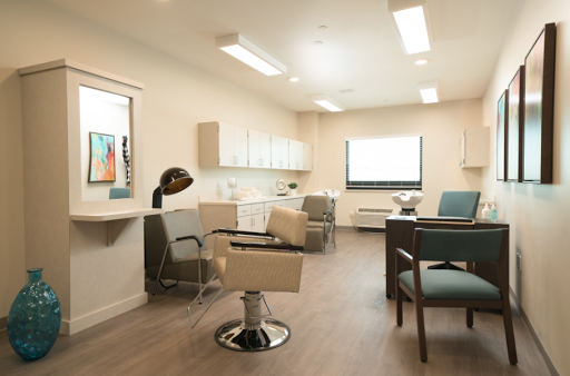 A modern and well-lit medical office featuring comfortable seating and professional decor.