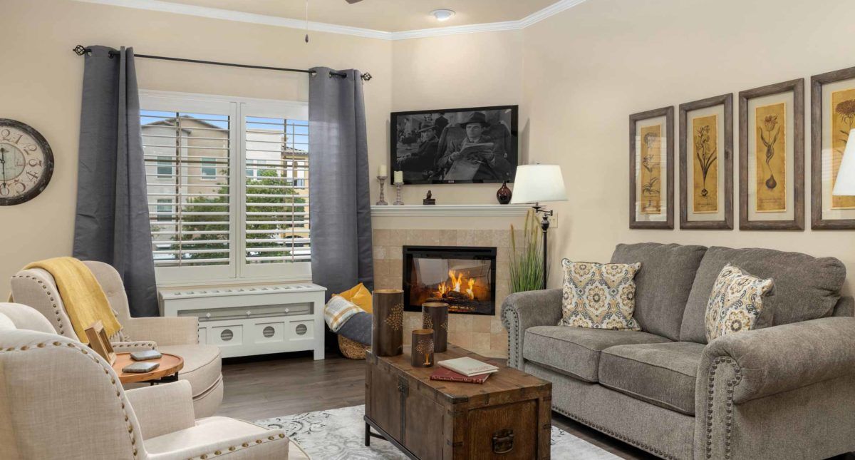 A cozy living room with a fireplace and comfortable seating.