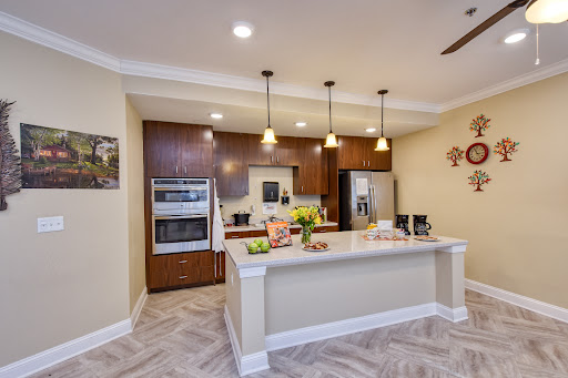 A modern kitchen featuring sleek cabinets, stainless steel appliances, and elegant lighting.