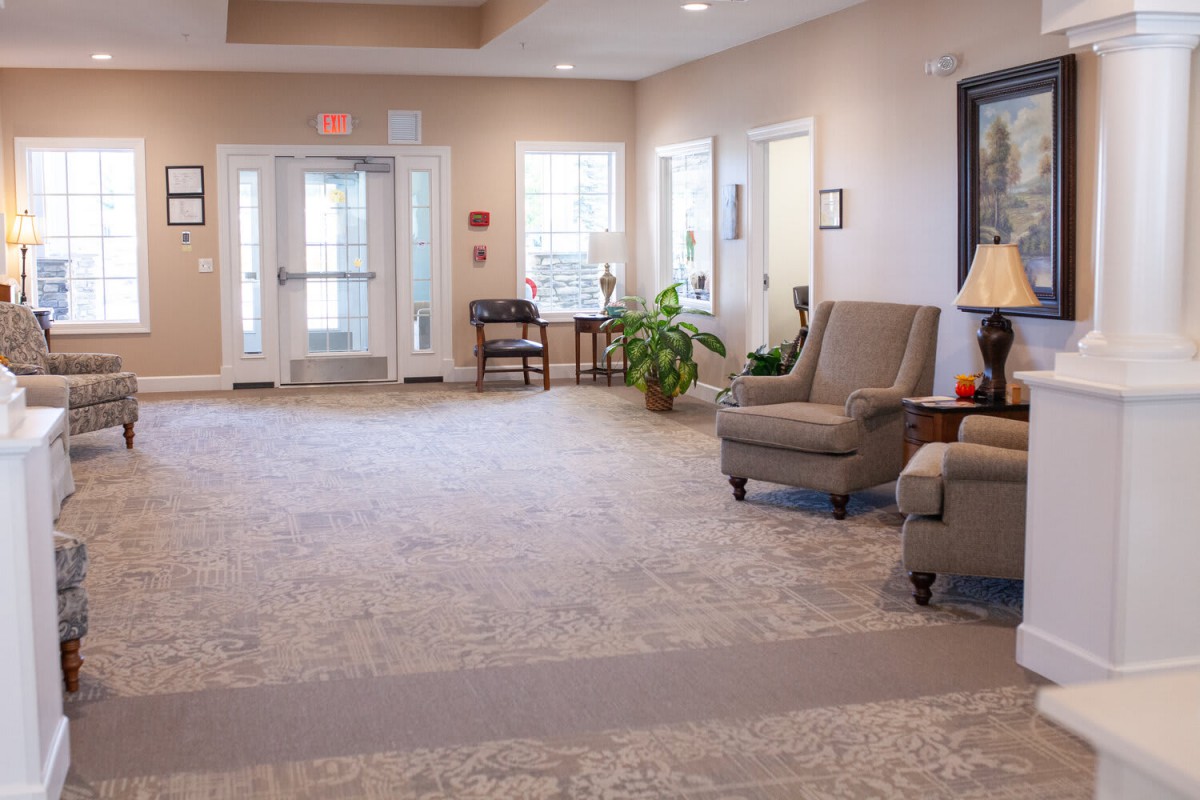 A cozy living room with comfortable seating and decorative elements.