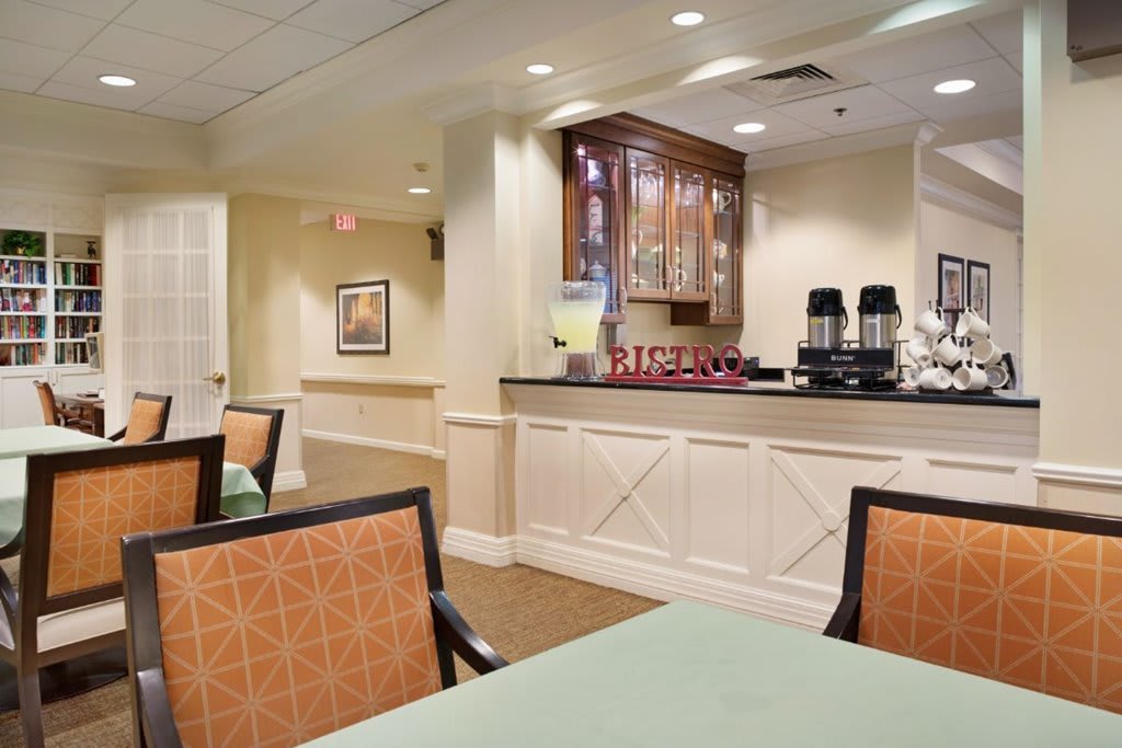 A cozy dining area with a coffee station and comfortable seating.