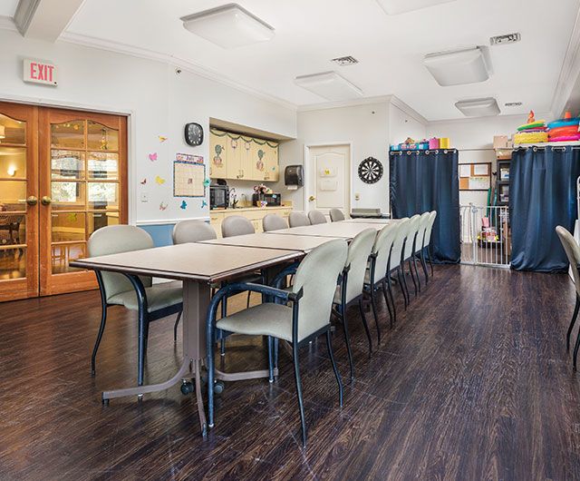 A spacious conference room with a long table and chairs, ready for meetings.