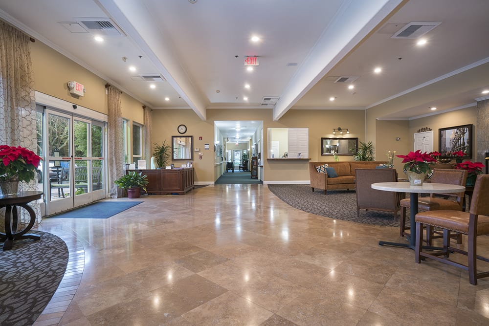 A spacious and well-lit lobby area with seating and a reception desk.