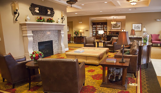 A cozy and inviting living room featuring a fireplace, comfortable seating, and warm decor.