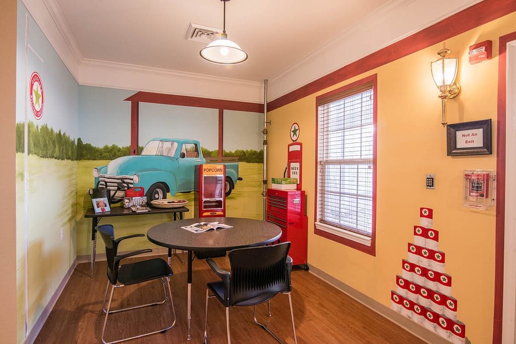 A retro-themed diner interior with vintage decor and a wall mural.
