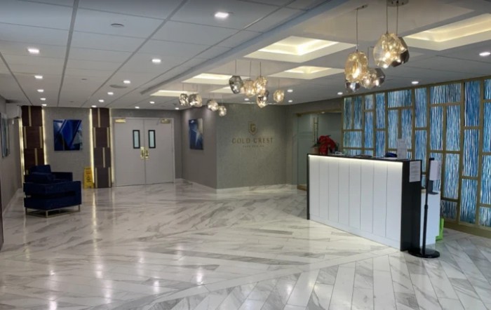 A modern lobby with marble flooring and elegant lighting fixtures.