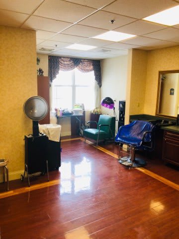 A cozy hair salon interior with styling chairs and equipment.