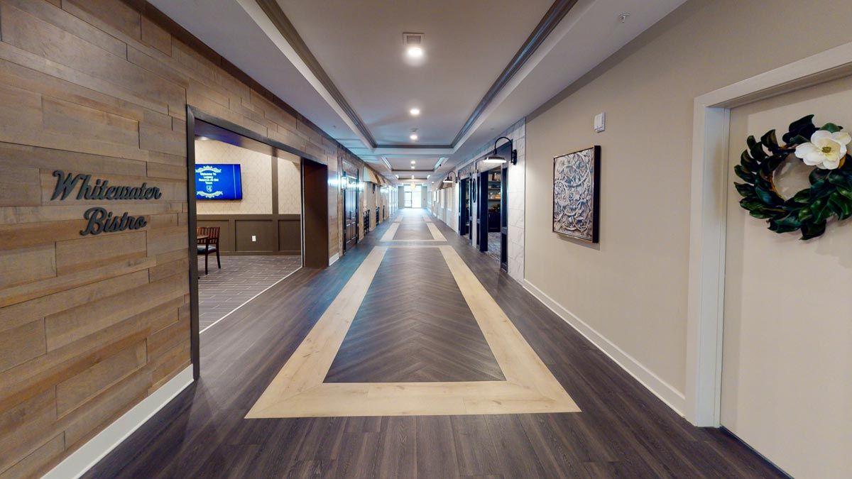 A modern hallway with sleek flooring and decorative artwork on the walls.