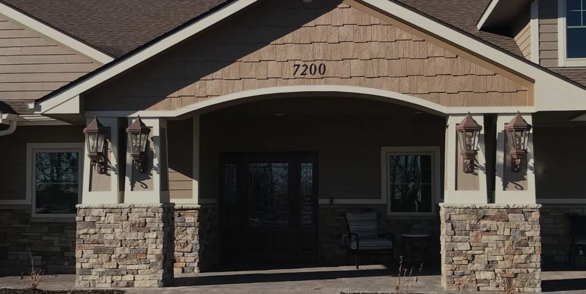 An entrance to a building with the house number 7200 displayed above the door.
