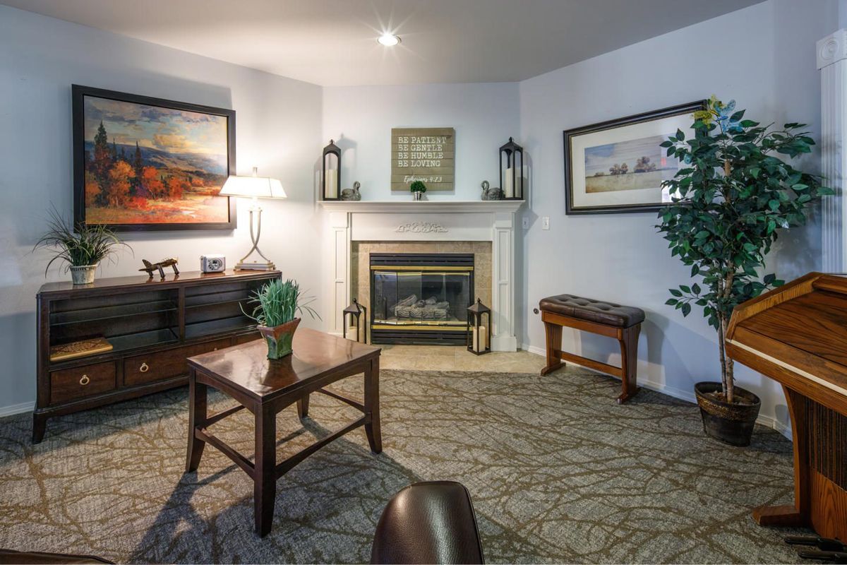 A cozy living room with a fireplace and stylish furniture.