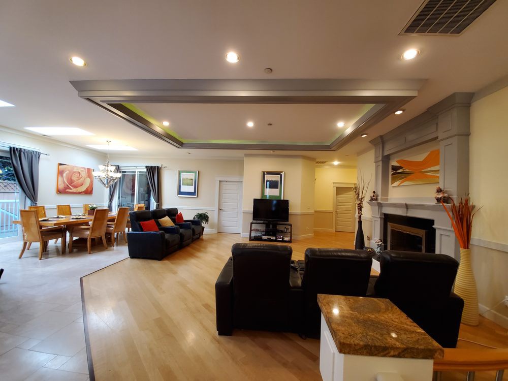 A spacious and modern living room featuring a comfortable seating area, a dining space, and elegant interior design elements.