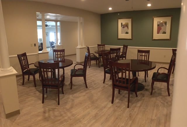 A cozy dining area with round tables and wooden chairs arranged neatly.